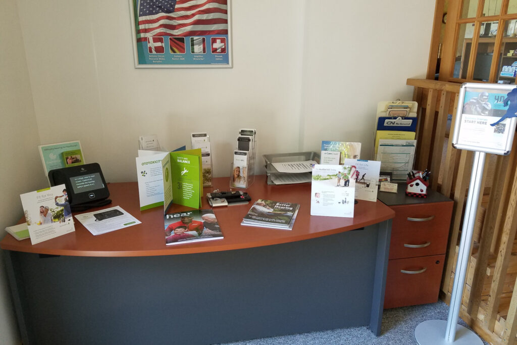 table with various brochures for hearing aids